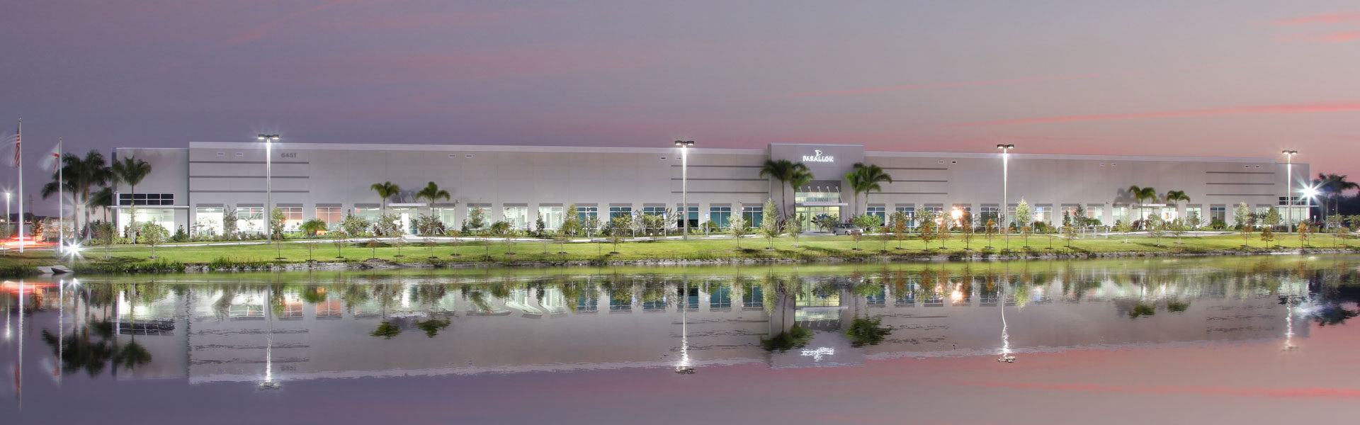 Parallon facility in Largo illuminated at dusk across the pond